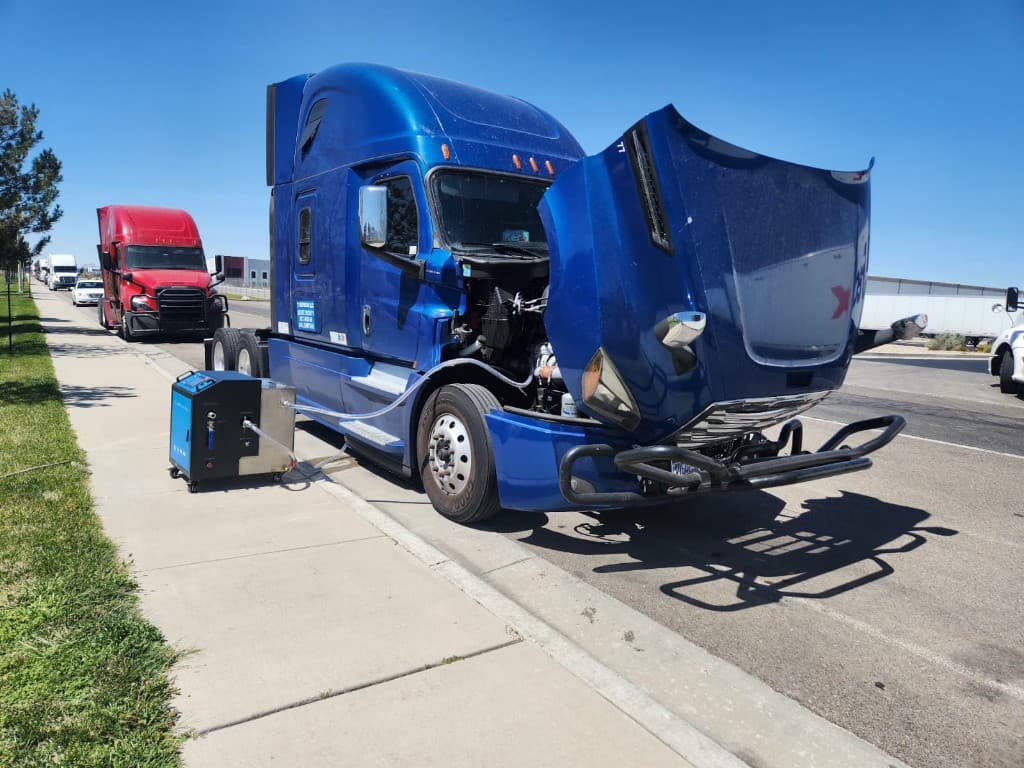 On-site DPF cleaning performed on a blue semi truck